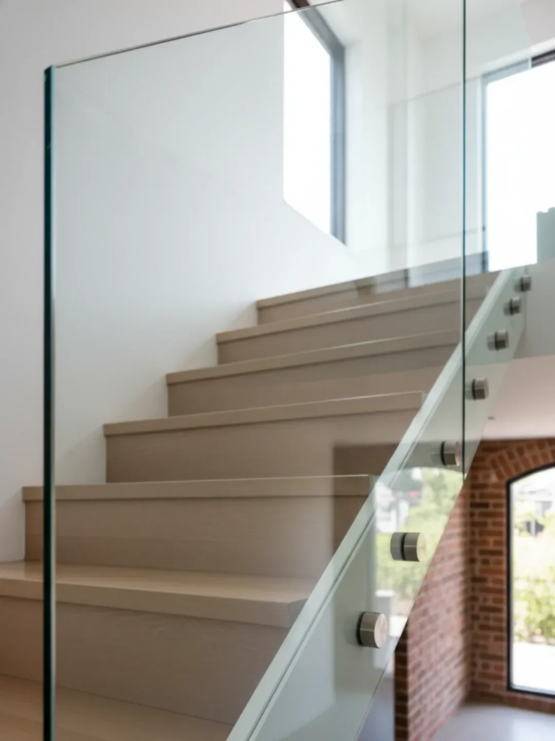 Raked glass panels for staircase void glazing in a Bulimba home